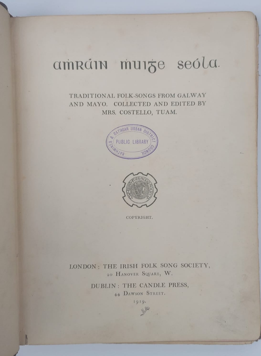 Open book with title page displaying text and a logo on a white background