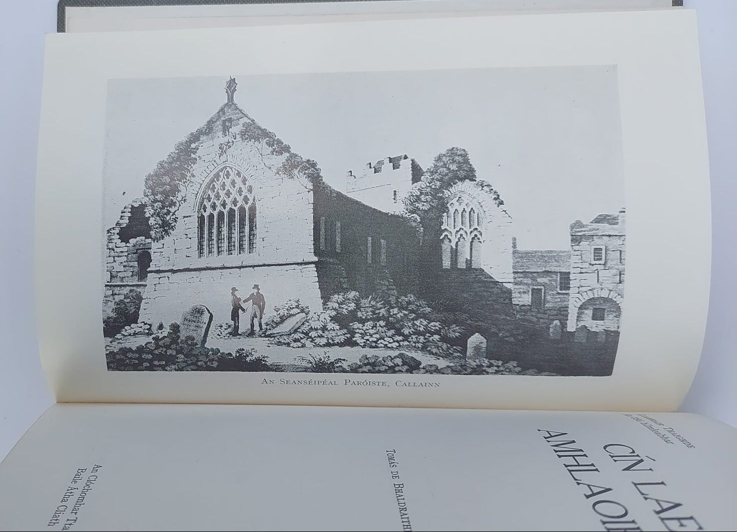 Open book with black and white illustration of a building on a plain background