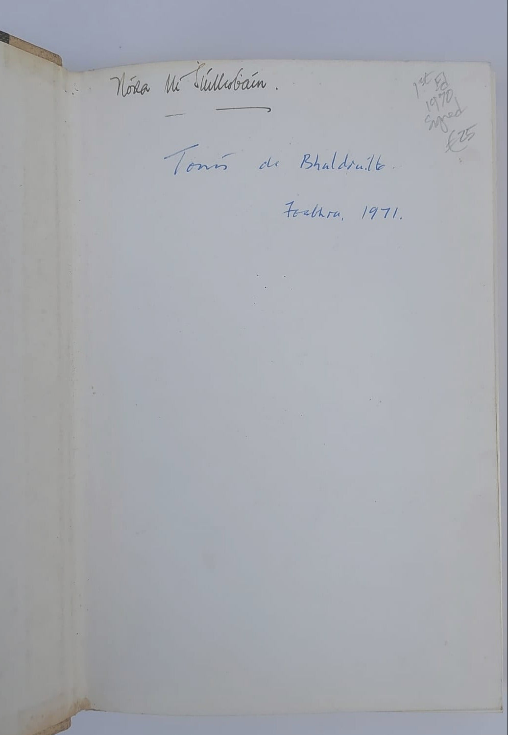Open book with handwritten text and a signature on a plain background